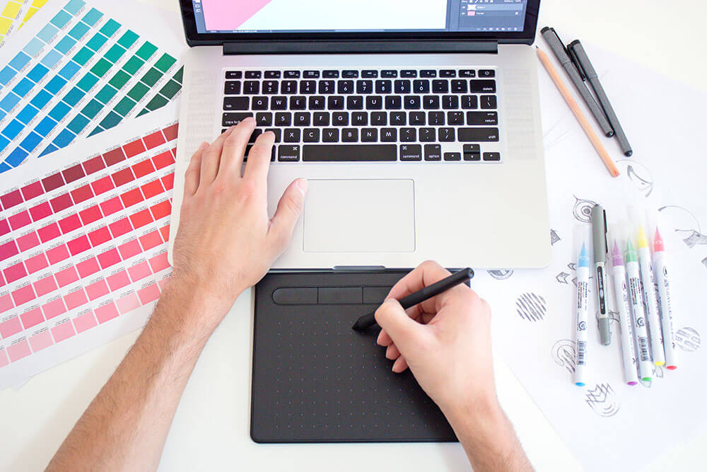 graphic designer working on a project on his computer